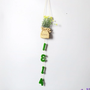 Detail of burlap pouch with love text and green flocked numbers 1314 for home decoration