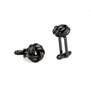 Macro view of polished black twisted knot cufflinks for men's formal dress shirt