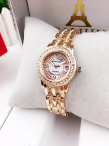 Detail of rose gold ladies watch with crystal bezel and Roman numeral shell dial