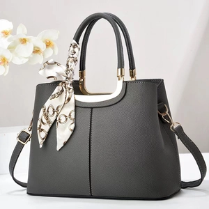 Dark grey lychee textured handbag with gold hardware and decorative scarf accent