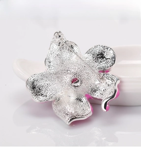 Detail view of the silver alloy rose brooch back featuring a secure metal pin clasp