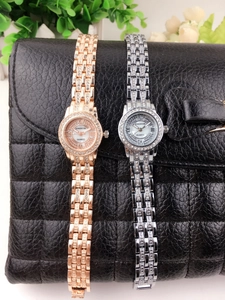 Close-up of gold and silver women's watches with rhinestones and Roman numerals.