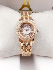 Detailed view of a luxury rose gold ladies watch with crystal bezel and Roman numerals.