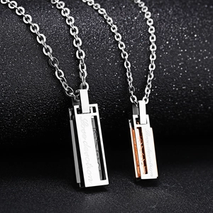 Polished silver and rose gold bar necklaces with Love Devotion engraving on black background