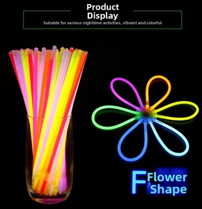Flower-shaped luminous glow stick assembly on black background with vibrant neon colors