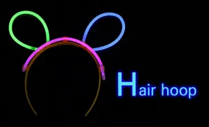 Glow-in-the-dark rabbit ear headband with four-color neon sticks on dark background