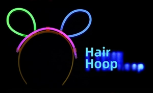 Glow-in-the-dark rabbit ear headband with four-color neon sticks on dark background