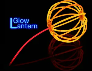 Detail of a DIY lantern made from orange glow sticks and a red handle for festive events