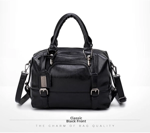 Detail of elegant black crocodile pattern PU leather Boston bag with metal plate