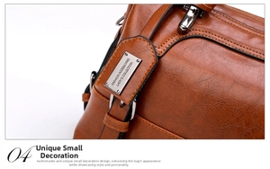 Close-up of vintage brown faux leather texture and silver metal brand plaque on handbag