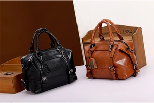 Detail view of vintage oil-wax leather texture on black and brown handbags