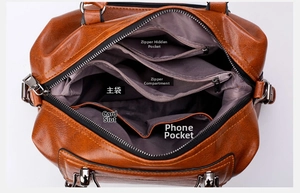 Detailed interior of brown leather tote showing zipper pockets and phone compartments