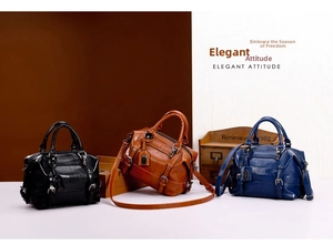 Three elegant Boston handbags in black, brown, and dark blue with glossy crocodile texture