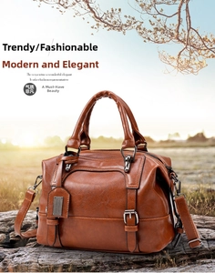 Detail view of a vintage dark brown shoulder bag on a rustic wood trunk in autumn