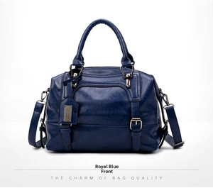Front view of royal blue Boston bag in crocodile texture with top handles and silver logo