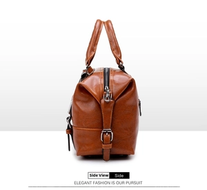 Detailed side view of brown oil wax leather boston bag with metal zipper and fine stitching