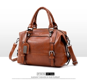 Detail view of brown crocodile texture shoulder bag with dual handles and side profile
