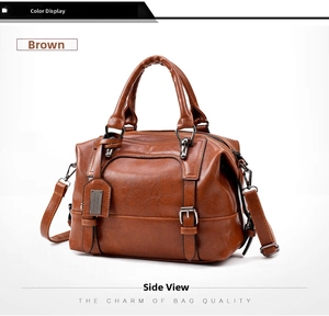 Detail view of tan crocodile pattern Boston bag showing side structure and leather texture