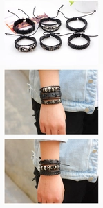 Detail of six-piece punk leather bracelet set featuring metal skulls and woven patterns