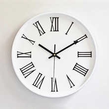 Close-up of minimalist white clock face with classic black Roman numerals and three hands