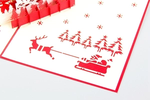 Close-up of 3D pop-up Christmas card featuring Santa's sleigh and reindeer detail