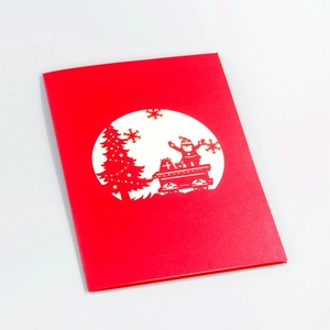3D pop-up Christmas card featuring Santa Claus on a red gift truck with a paper-cut tree