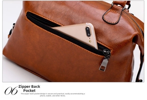 Detailed view of the back zipper pocket on a brown leather bag showing smartphone storage