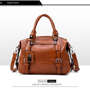 Brown crocodile texture Boston bag featuring metal brand plate and classic buckle straps
