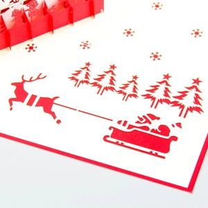 3D pop-up Christmas card featuring laser-cut Santa sleigh and reindeer paper art