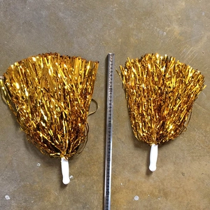 Close-up of golden cheerleading pom poms with handles measured at 30cm and 35cm length