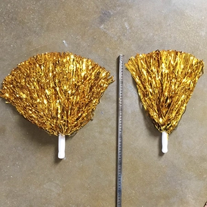 Close-up of gold cheerleading pom poms with white handles showing 35cm size measurement