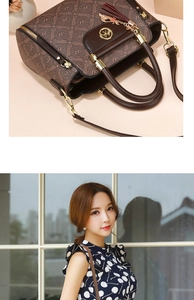 Detail view of brown monogram handbag with golden hardware and leather tassel charm