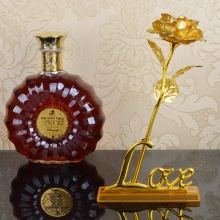 Detailed view of a golden rose craft piece resting on a metal stand with LOVE inscription