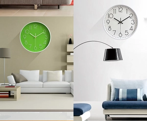Detail view of modern silent wall clocks in vibrant green and white minimalist designs