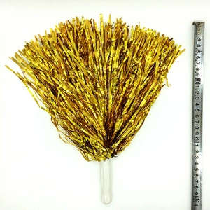 Detail view of a 30cm gold metallic pom pom with plastic handle and ruler scale