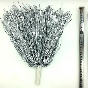 Close-up of silver cheerleader pom pom with white handle and measuring tape for size scale
