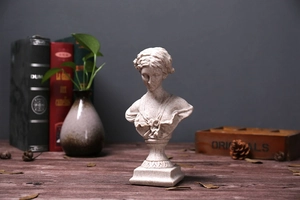 Detail of Venus bust sculpture with stone-like texture in a vintage home setting