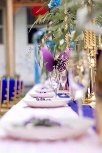 Detail of a purple laser-cut butterfly card used for wedding glass decoration