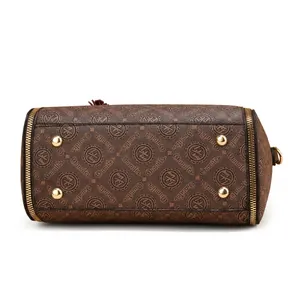 Detail display of the brown logo handbag bottom featuring four gold protective feet
