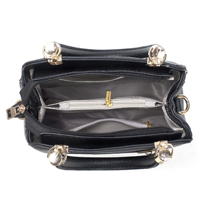 Classic black leather tote bag featuring multiple interior compartments and gold metal zippers