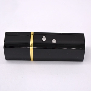 Macro shot of two transparent silicone earring backs on a black and gold decorative stand
