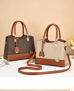 Close-up of vintage monogram shoulder bags with golden buckles and leather straps