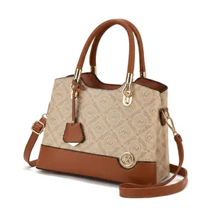 Detail of beige and brown leather tote bag featuring classic monogram print and golden hardware