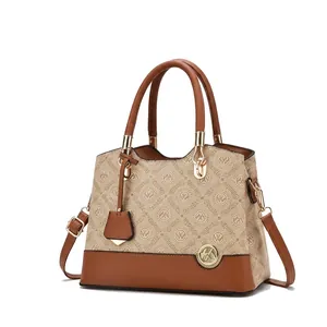 Detail of Oumifei monogram fabric, leather handles and elegant metal logo pendant charm