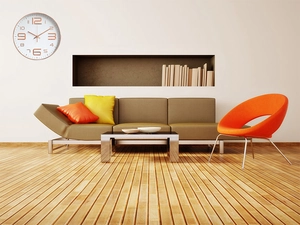 Detail view of silent wall clock with rose gold numbers in a modern living room