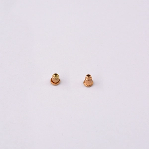 Macro shot of rose gold bullet clutch earring backs showing metallic texture and structure