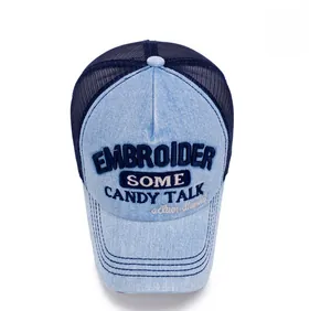 Detail of blue denim baseball cap with breathable mesh and custom text embroidery