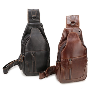 Front view of black and dark brown leather chest bags showing zippers and texture