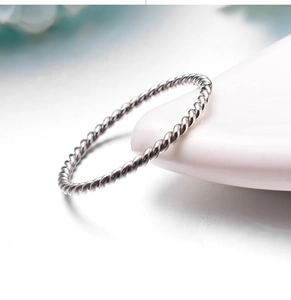 Macro shot of twisted rope texture and silver metallic luster on the stainless steel ring