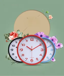 Detailed view of three modern silent quartz wall clocks in black, red, and blue colors